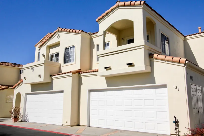 A two-storey townhouse with closed carport and tiled roofing in the Villa Aspara community.