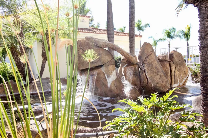 view of a pont in Villa Aspara with a rock fountain and certain plants and trees to complement its beauty
