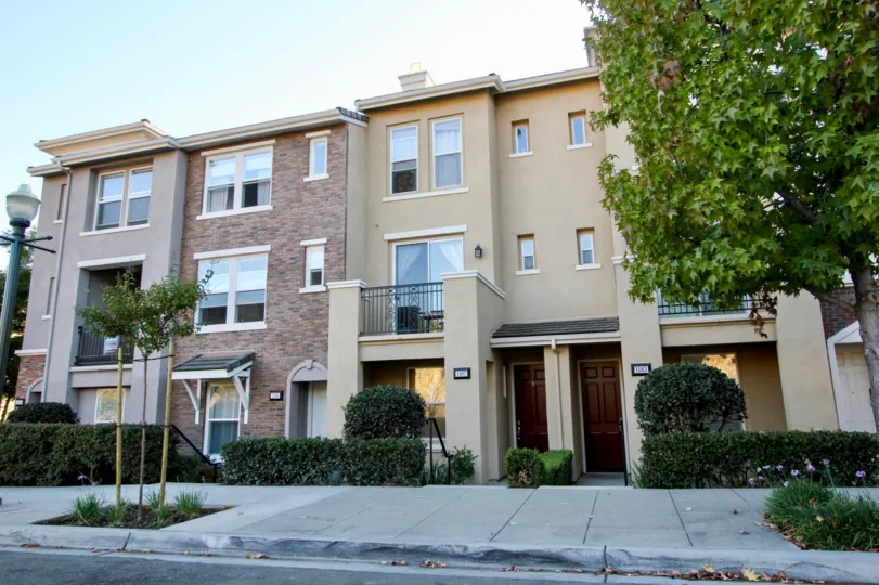 A three-storey townhouse with stone cladding in Village Square community.