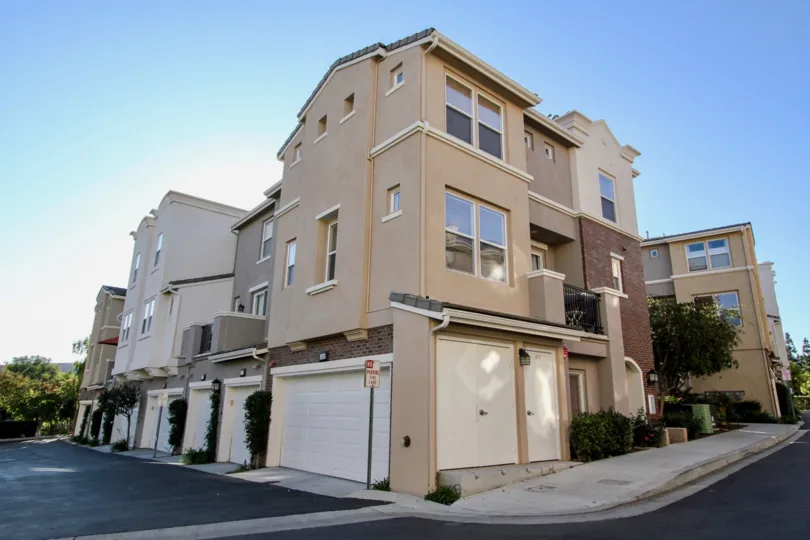 A sunny day in the area of Village Square, outside, condos, balcony, trees, garage