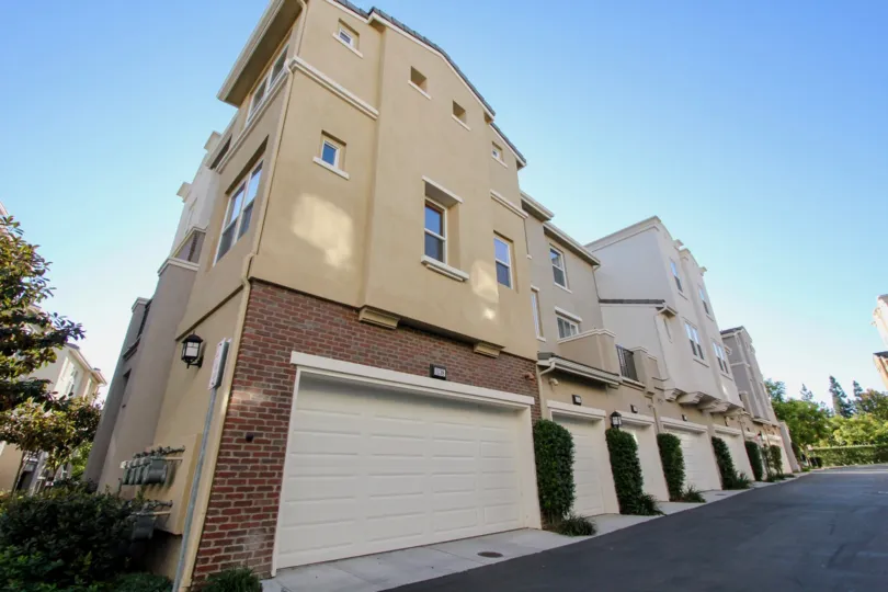 Garages sit on the first floor of a residential building in Village Square