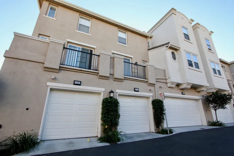 Village Square multi-story beige building with white garage doors San Marcos California