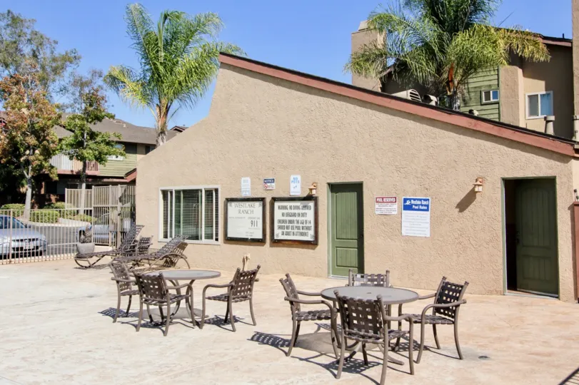 Two Dinning tables and sitting chairs are placed in front of the house in the Westlake Ranch