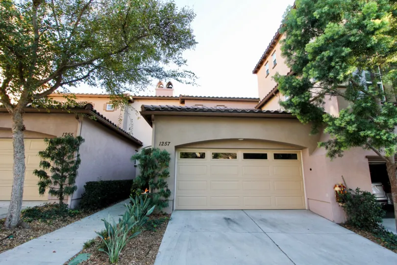 A sunny day in the area of Westridge, outside, condo, balcony, tree, garage, bush