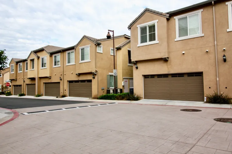A sunny day in the area of Aubrey Glen, street, parking area, garages, condos