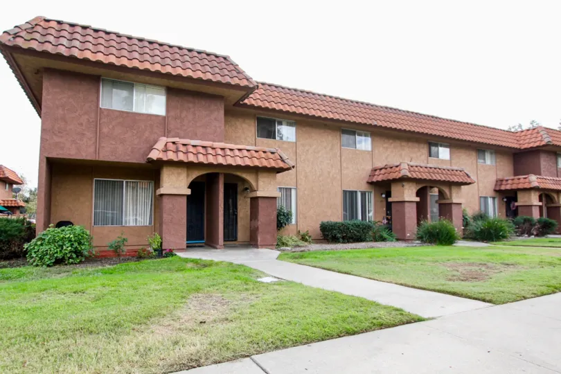 A sunny day in the area of Carlton Country Club Villas, brick wall, doors, windows, roof