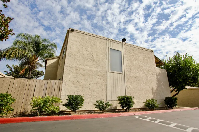 A sunny day in the area of Del Coronado Santee, parking lot, bushes, trees, cluds