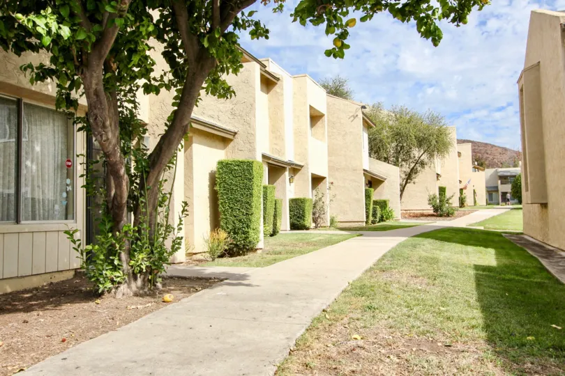 A sunny day in the area of Del Coronado Santee, parking lot, bushes, trees