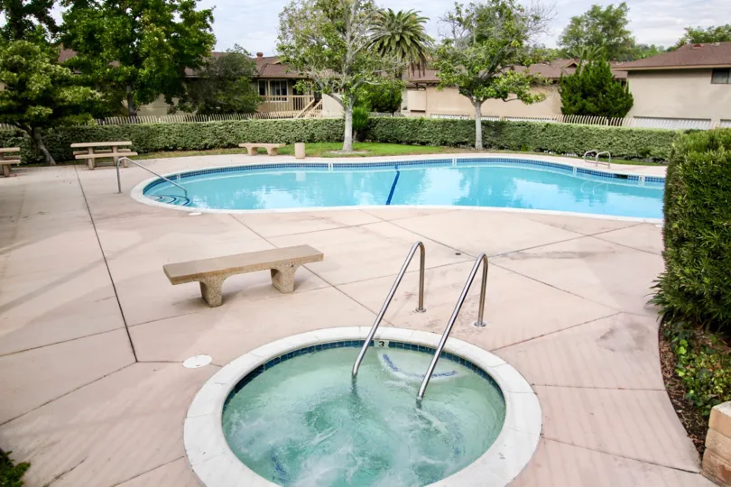 A bright and peaceful day at the Fletcher Valley Villas with refreshing swimming pools and jacuzzi and plenty of seating and greenery around
