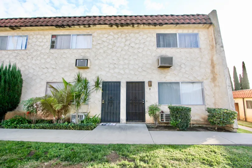 The front view of a rock faced apartment building in the Horizon Village community in Santee, California