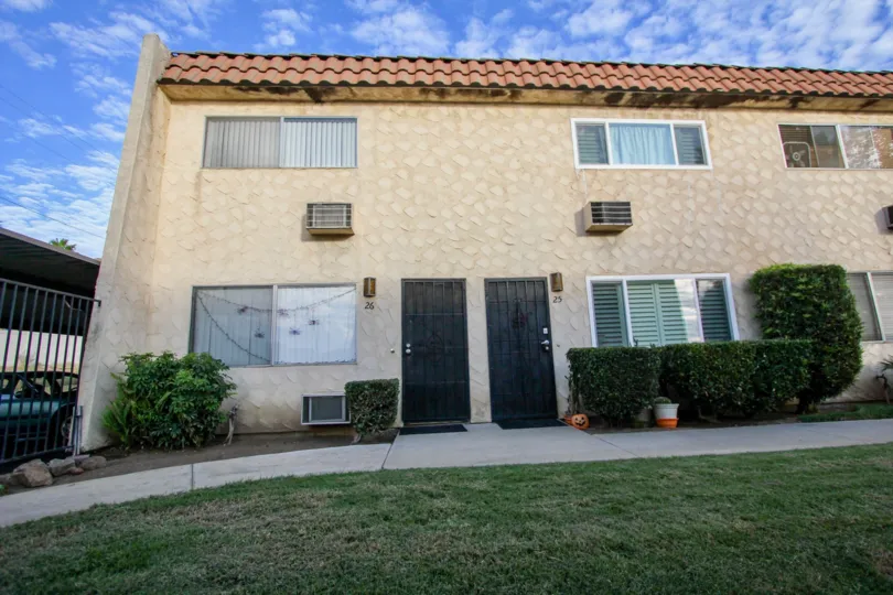 Two story housing units with green yard at Horizon Village in Santee California