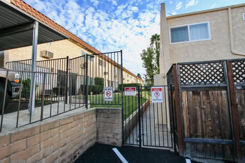 A sunny day in the area of Horizon Village, gated entrance, warning signs, fence, parking lot