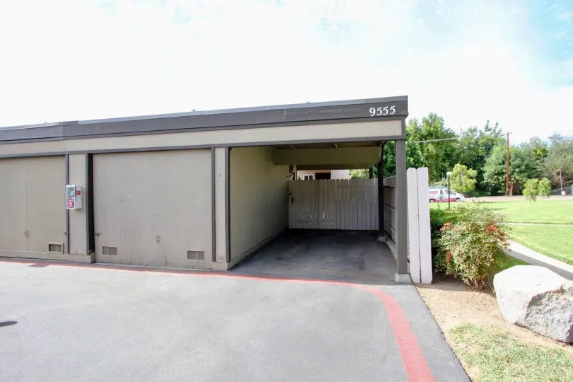 A sunny day in the area of Magnolia Meadows, garage, parking area, fence, grass