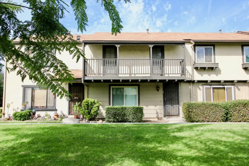 Two story apartments behind a green yard in the Magnolia Meadows in Santee California