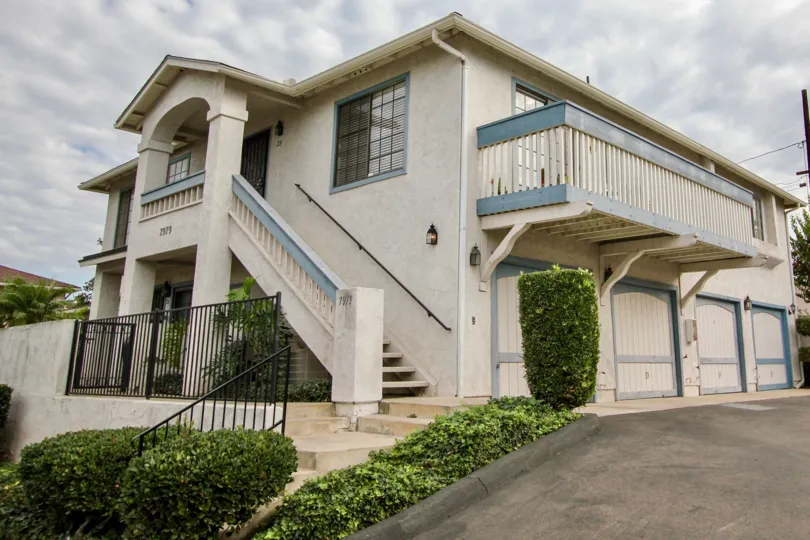 A sunny day in the area of Mission Martinique, stairs, tree, balcony, outside, bushes, garage