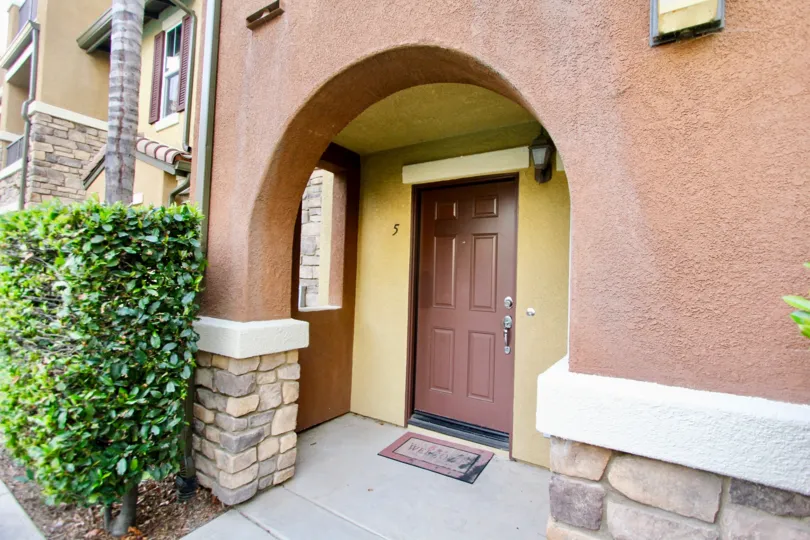 brown door with an archway leading to it in Morningside