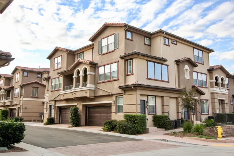A sunny day in the area of Northstar, condos, bushes, windows, garage, street