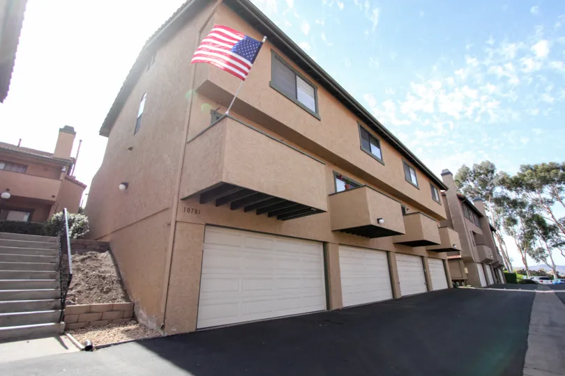 A sunny day with a flag flying from balcony at Riderwood Terrace in Santee