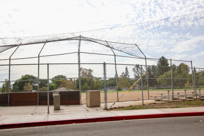 A sunny day in the area of Riderwood Village, baseball diamond, fence, water fountain