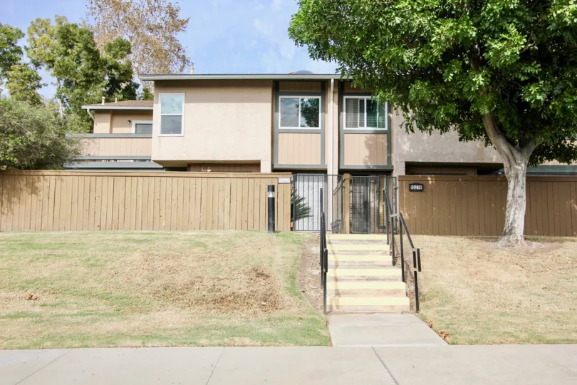 A sunny day in the area of Riderwood Village, stairs, walkway, condo, tree, window