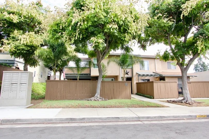 A brown privacy fence surrounds townhouses at Riderwood Village