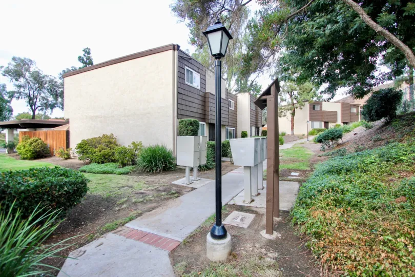 Mail boxes located next to the Rio Terrace homes along a paved path.