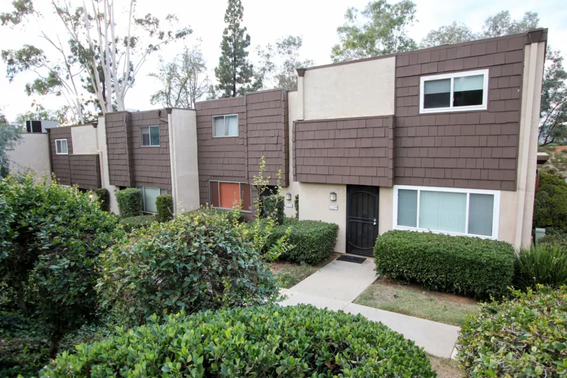 Rio Terrace,: Santee  , California,trimmed bushes,brown and white building