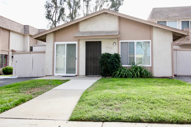 A sunny day in the area of Santana Ranch, condo, gated door, car, walkway