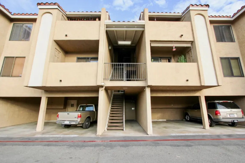 A sunny day in the area of Towne Villas, parking area, truck, suv, balcony
