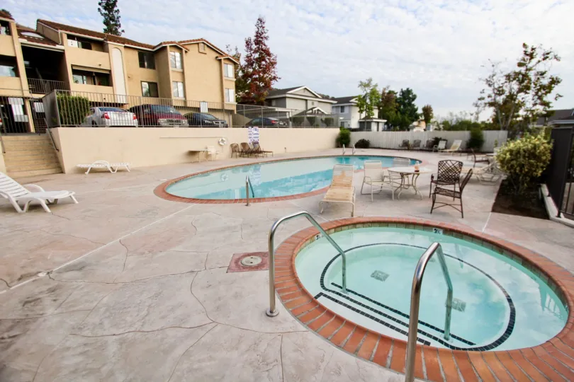 Towne Villas - Santee, California with spacious parking outside of apartments that overlook the community pool and hot tub