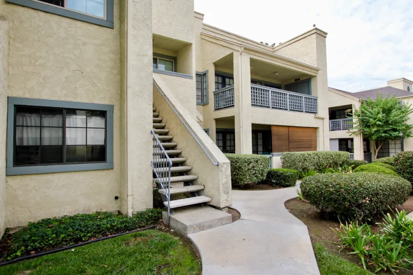 Some Stairs and a Hedgerow outside a block of apartments at Vista Del Rio in Santee California