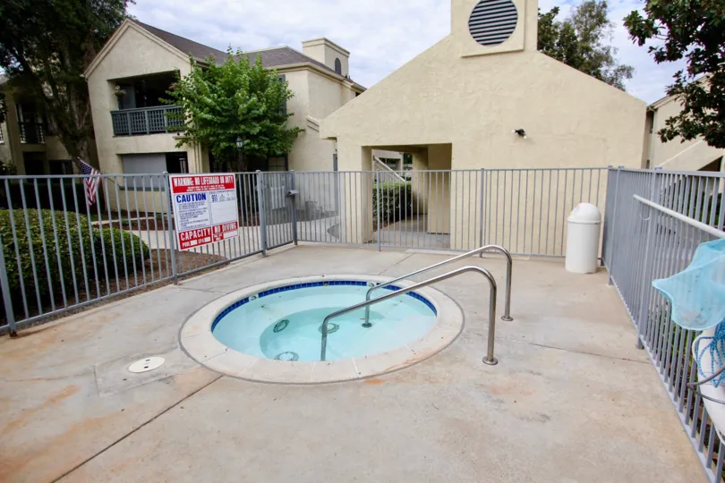 Hot tub surrounded by metal fence at the Vista Del Rio community in Santee California.