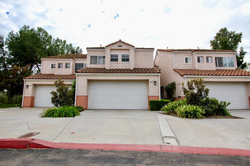 A sunny day in the area of Vista Del Verde, garage, driveway, bushes, tree