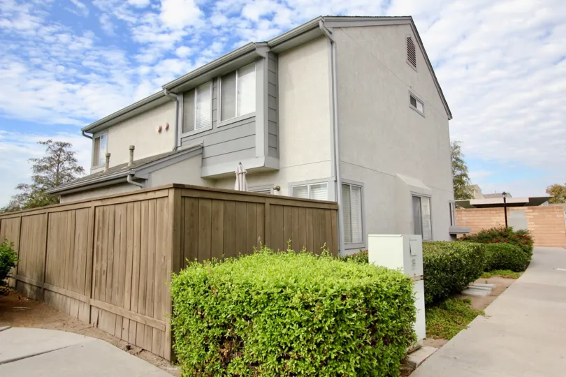 Two story house with fence and shrubs in Ashford Park, Spring Valley, CA