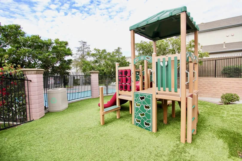 A sunny day in the area of Ashford Park, outside, playground, pool, fence, grass