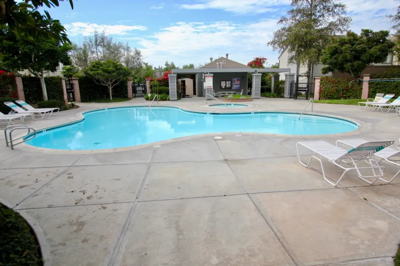 Area in front of swing pool with seating and view of facility