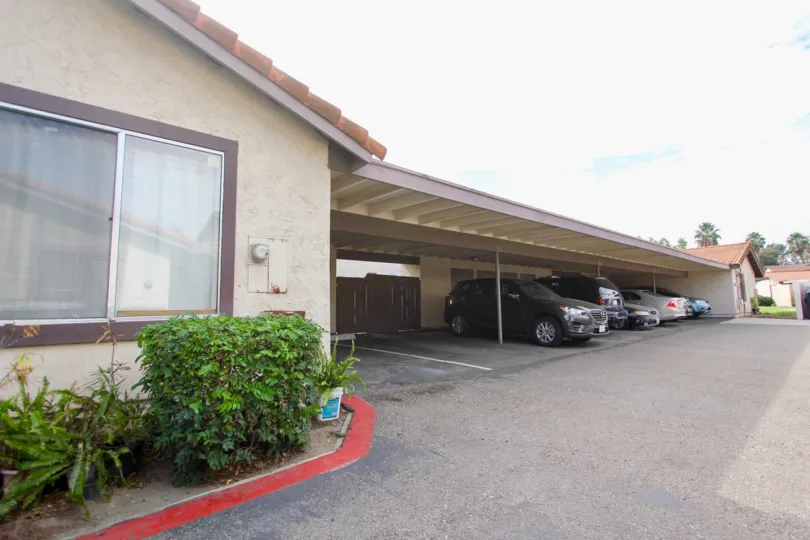 Cars parked in an overhang on a sunny day at Bonita Grande