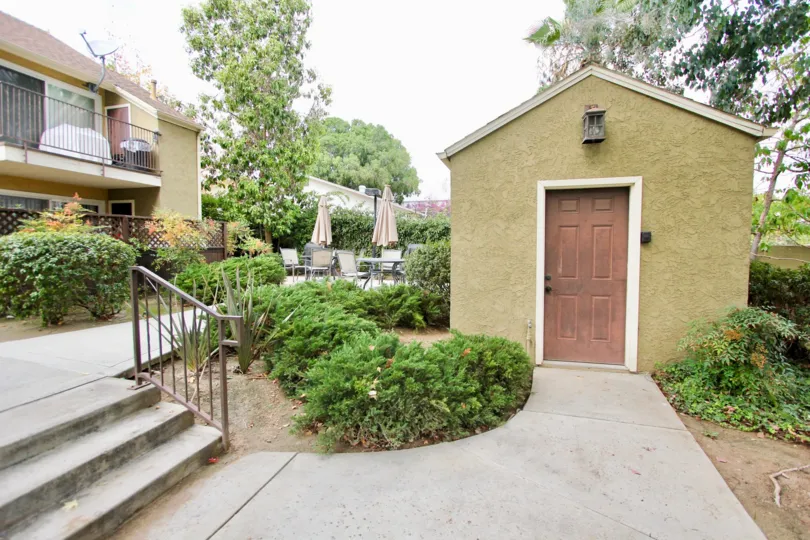 A sunny day in the area of Canyon Villas, stairs, door, condo, tree, umbrella