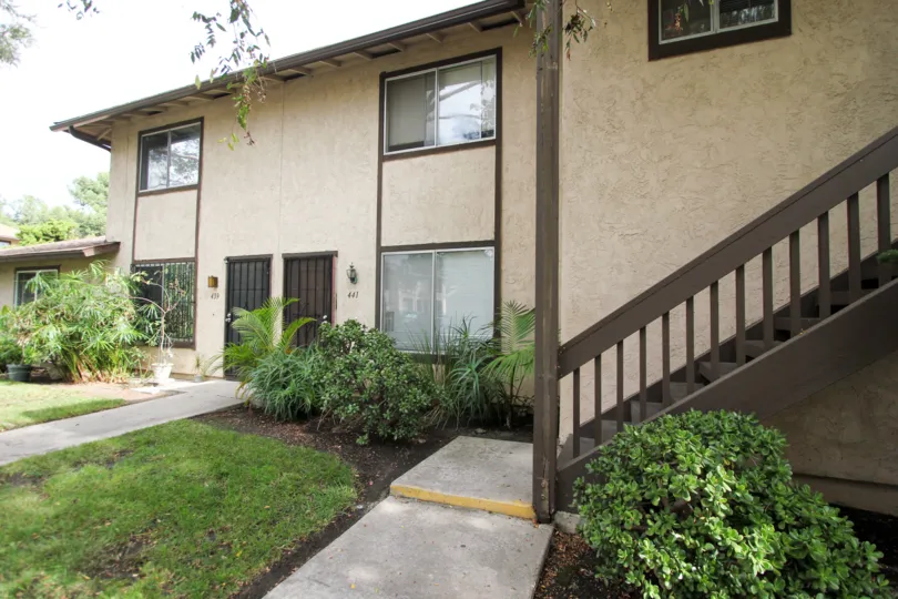 A sunny day in the area of Carefree South, outside, condos, stairs, trees, windows