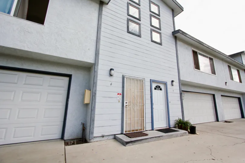 A plain low-rise apartment with square windows and closed garages in Goodland Acres neighborhood.