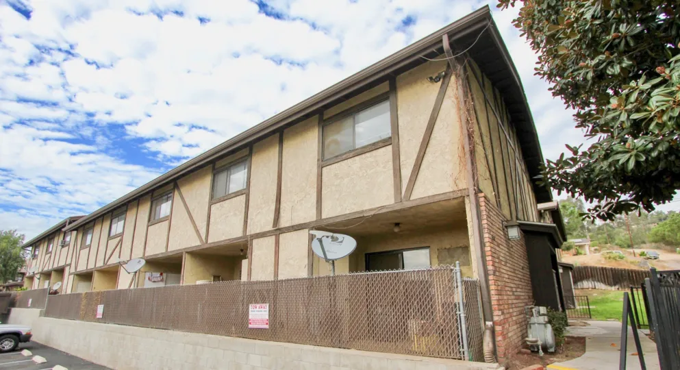 A long residential building with a rust encrusted storm drain at Hartland in Spring Valley CA
