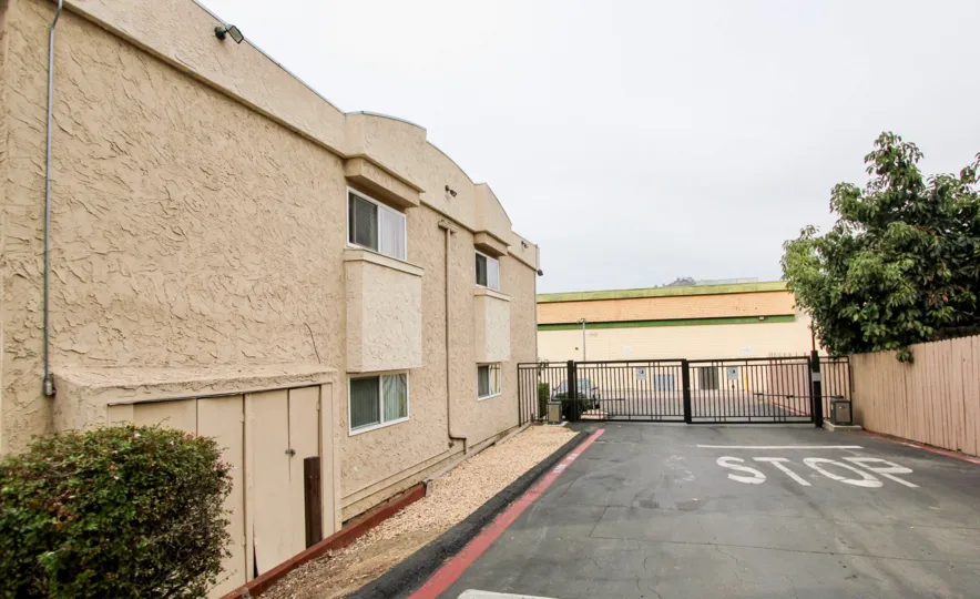 A sunny day in the area of Helix De Oro, outside, gate, condos, driveway, trees