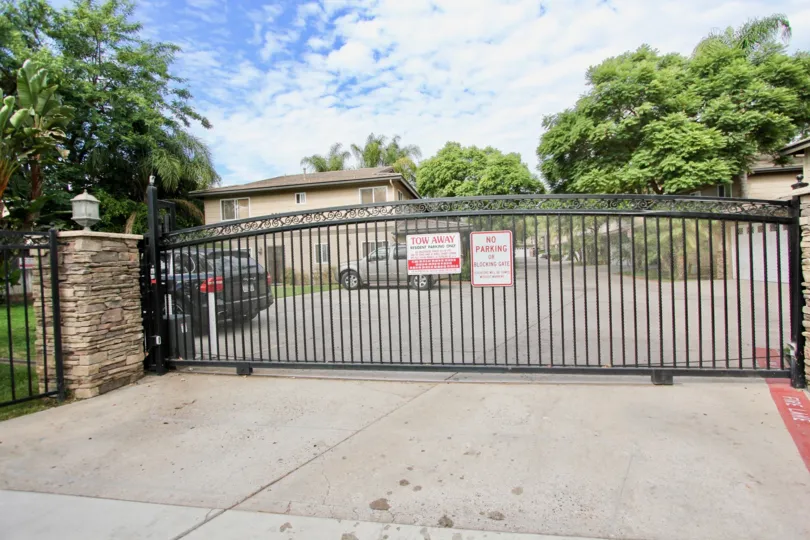 THE HOUSE IN THE LAMAR SQUARE WITH THE CAR PARKING, NO PARKING BOARD, TREES, PLANTS, LAWN