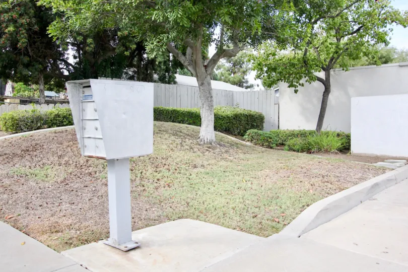 A view of a mailbox in front of a tree in the Lamar Townhomes community in Spring Valley, California
