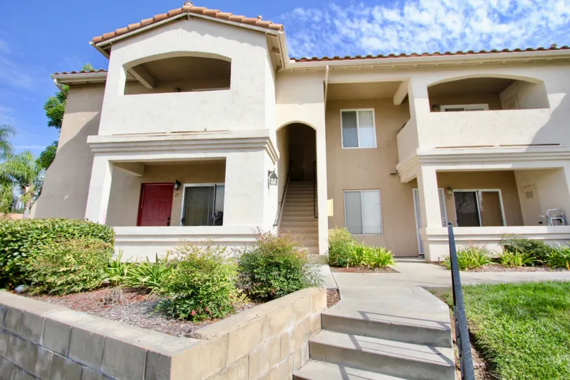 A view of the front exterior and entrances to a four unit building at the Quarry Homes community.