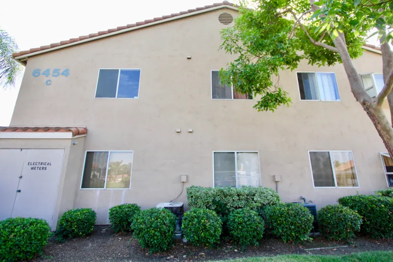 Two story housing structure with plants and trees at Quarry Palms in Spring Valley California