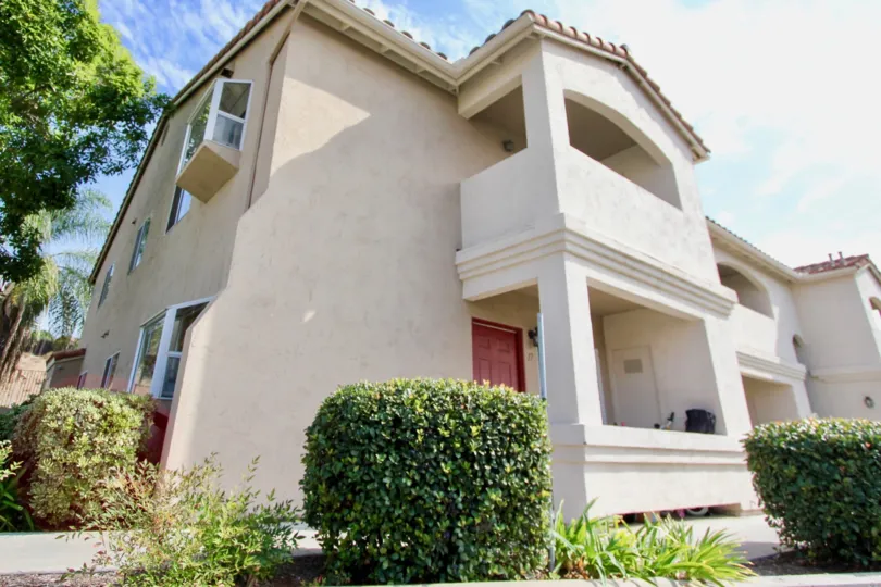 A red door sits on the front of a two story home in the Quarry Palms community in Spring Valley California.