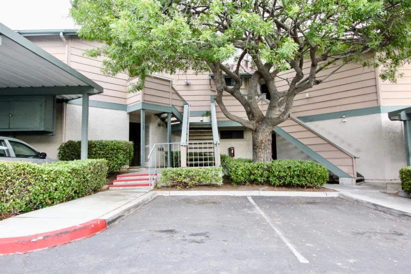 Ranchwood Park beige and creme and green building with stairs and covered parking Spring Valley California