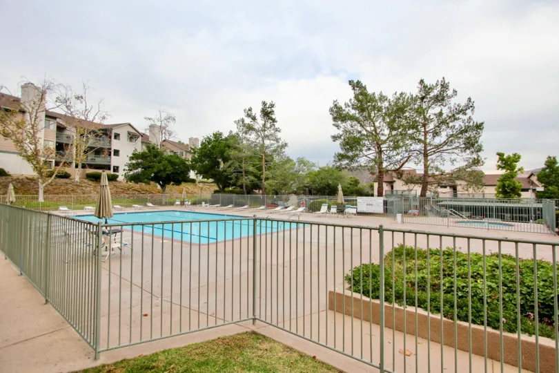 Large community pool surrounded by metal fence at Ranchwood Park in Spring Valley California