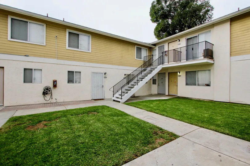 Exterior view of grassy outdoor area of Sandstone Community apartments in Spring Valley, California